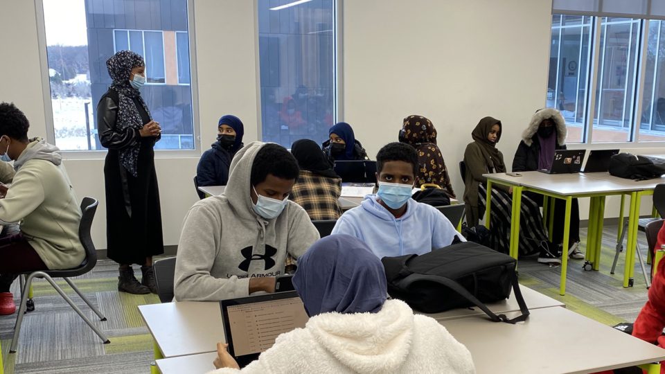 Students in classroom with adult