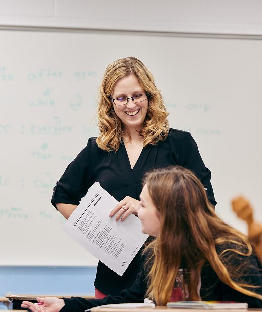 A teacher smiling at a student